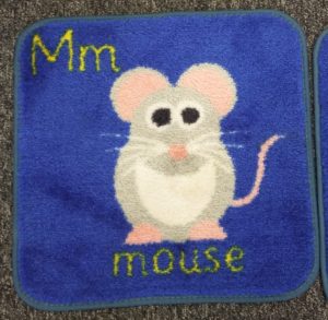 Carpet tile with mouse and letter M