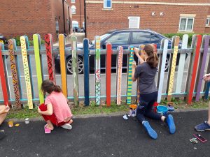 Two local children busy painting their designs